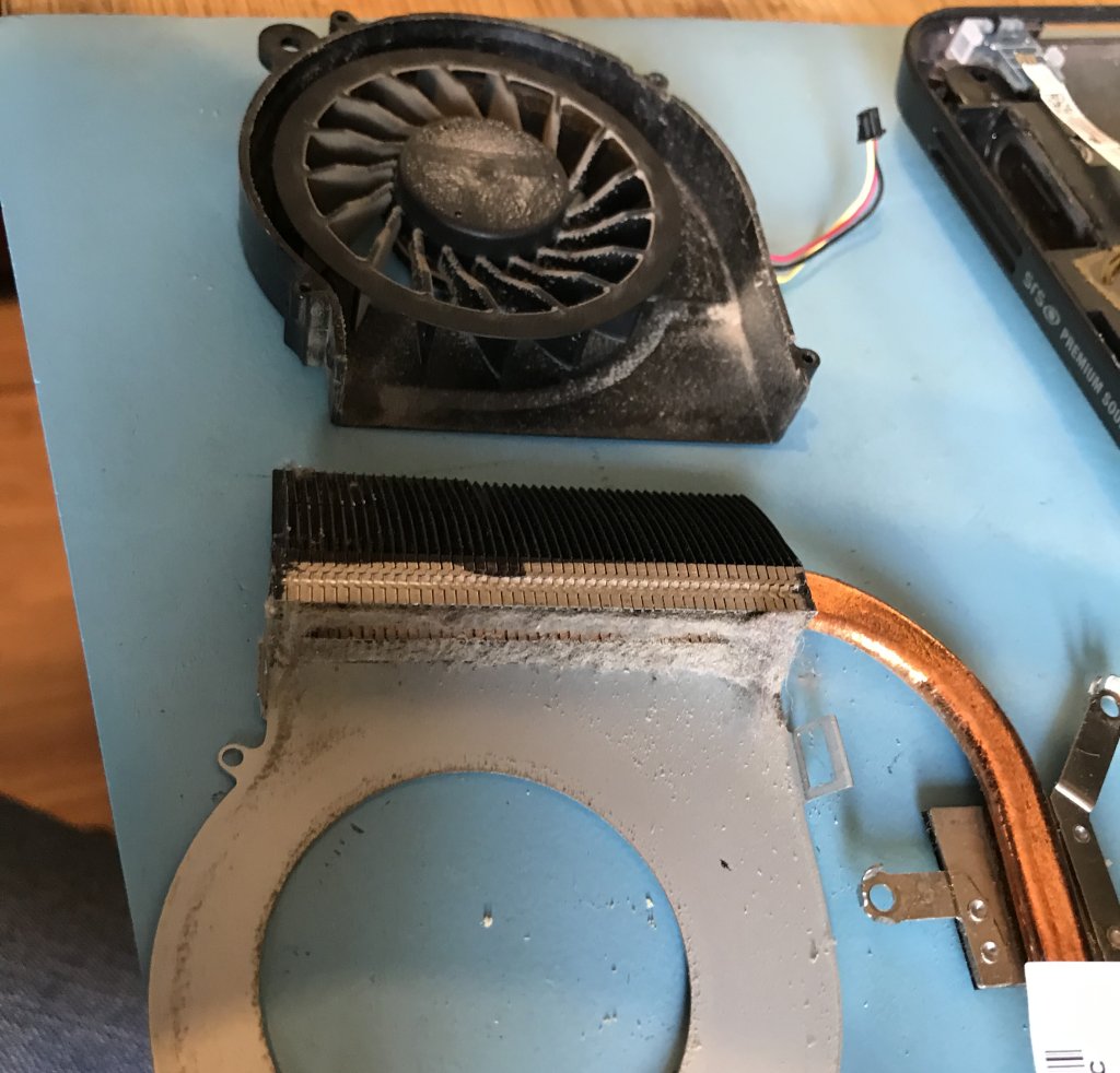 Dusty fan and heatsink assembly from a laptop